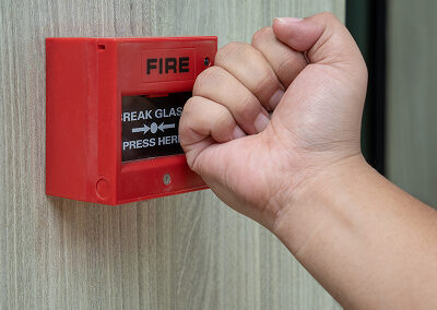 Fire alarm box with human hand action crush glass emergency situation